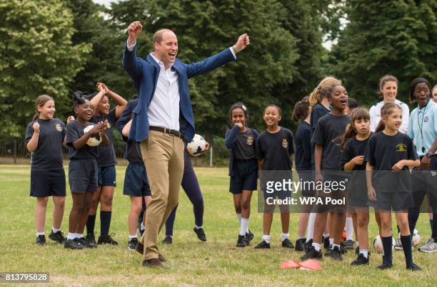 Prince William, Duke of Cambridge celebrates scoring a goal during a kick-about with the Lionesses and local girls team from the Wildcats Girl'...