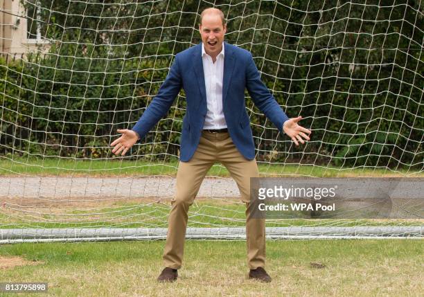 Prince William, Duke of Cambridge takes his turn in goal during a kick-about with the Lionesses and local girls team from the Wildcats Girl' Football...