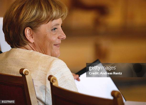 German Chancellor Angela Merkel smiles at Leipzig city hall on June 3, 2008 in Leipzig, Germany. Merkel received the honorary Doctorate for her...