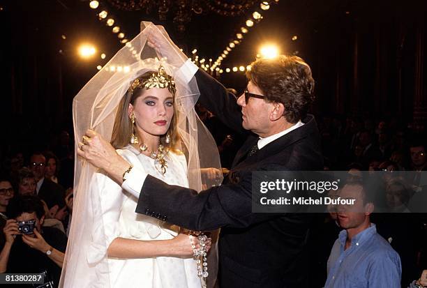 Model wedding dresses and Yves Saint Laurent walk on the catwalk at YSL High Fashion Show Spring/Summer 1991 during the fashion week 1990 in Paris,...