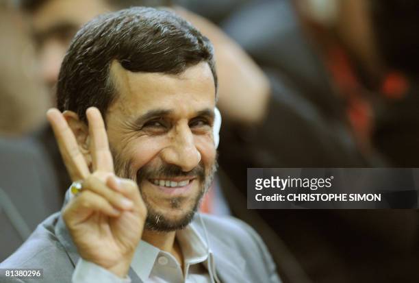 Iranian President Mahmoud Ahmadinejad makes the "V-sign", before delivering his speech during three-day summit on food security at UN Food and...