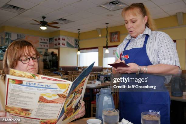 Waitress takes order from a woman at the International House of Pancakes.