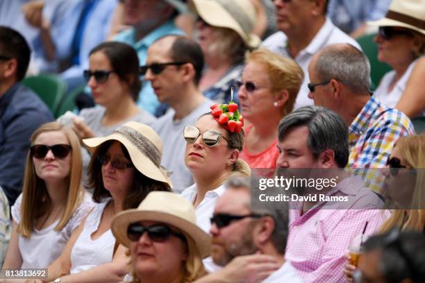 Spectator dons strawberry themed headwear on day ten of the Wimbledon Lawn Tennis Championships at the All England Lawn Tennis and Croquet Club at...