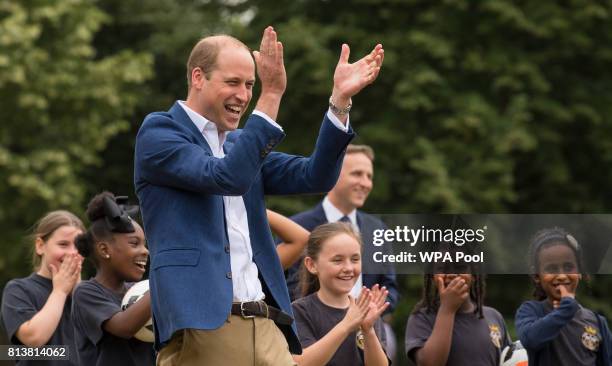 Prince William, Duke of Cambridge laughs and applauds as he attends a kick-about with the Lionesses and local girls team from the Wildcats Girl'...