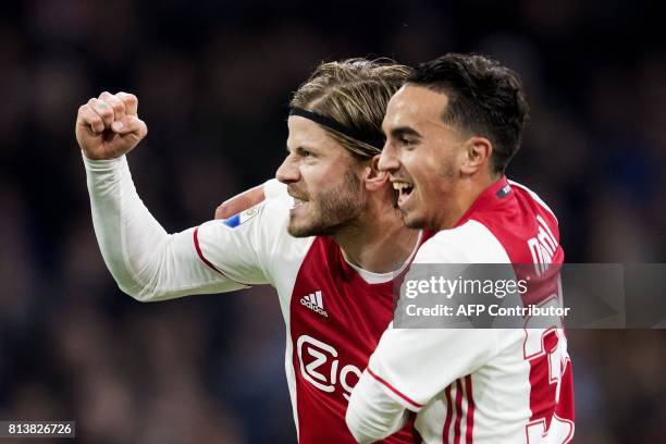 Ajax's Dutch midfielder Abdelhak Nouri and Lasse Schone react during a football match on April 5, 2017 in Amsterdam. Abdelhak Nouri has suffered...