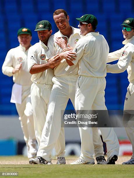Stuart Clark of Australia celebrates with teammates after dismissing Xavier Marshall of West Indies on day five of the Second Test match between West...