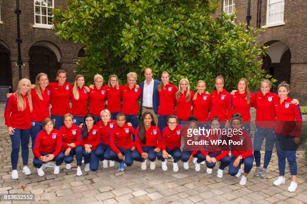 Prince William, Duke of Cambridge and members of the England Women football team pose for a group photograph during a reception for the England Women...
