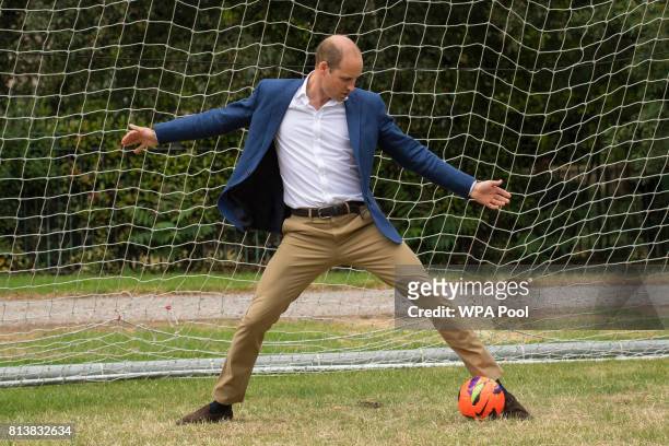 Prince William, Duke of Cambridge takes his turn in goal during a kick-about with the Lionesses and local girls team from the Wildcats Girl' Football...