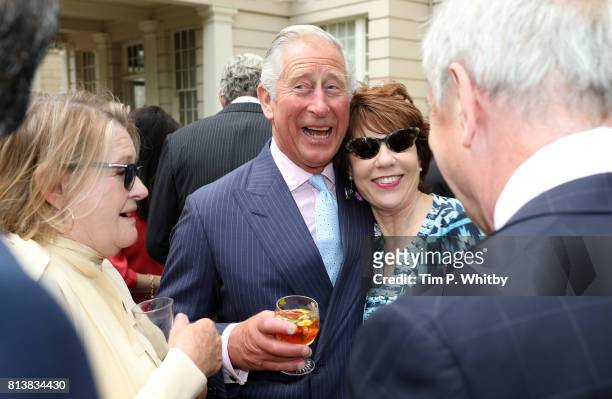 Prince Charles, Prince of Wales greets Kathy Lette at a reception to mark The Duchess of Cornwall's 70th birthday at Clarence House on July 13, 2017...