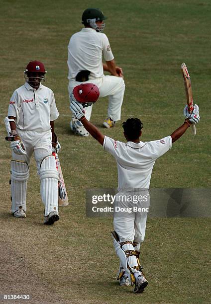 Ramnaresh Sarwan of West Indies raises his bat to celebrate his century with teammate Shivnarine Chanderpaul, on day five of the Second Test match...