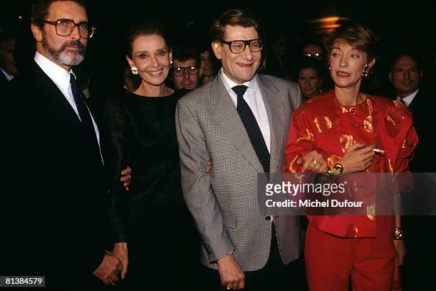 Audrey Hepburn and her husband, Yves Saint Laurent and Loulou de la Falaise attend a Givenchy party in 1990 in Paris, France.
