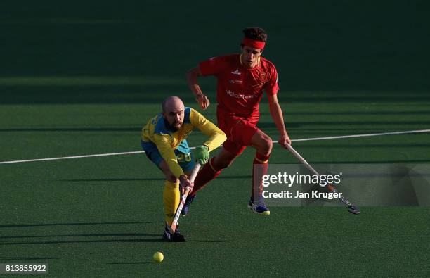 Matthew Swann of Australia passes the ball under pressure from Enrique Gonzalez during day 3 of the FIH Hockey World League Semi Finals Pool A match...