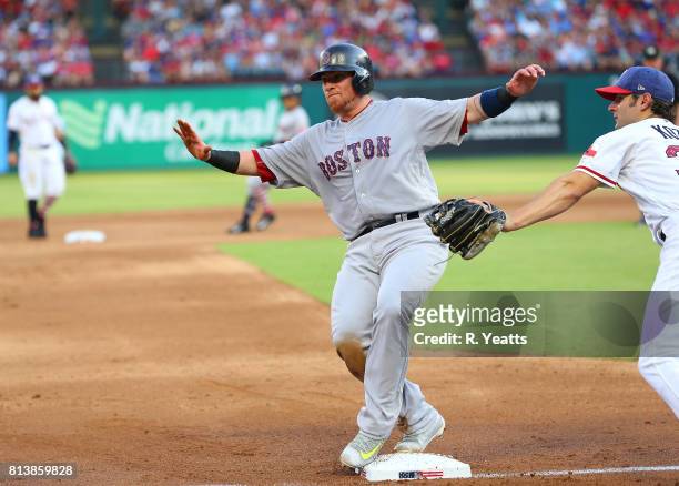 Pete Kozma of the Texas Rangers misses the tag in the second inning on Christian Vazquez of the Boston Red Sox at Globe Life Park in Arlington on...
