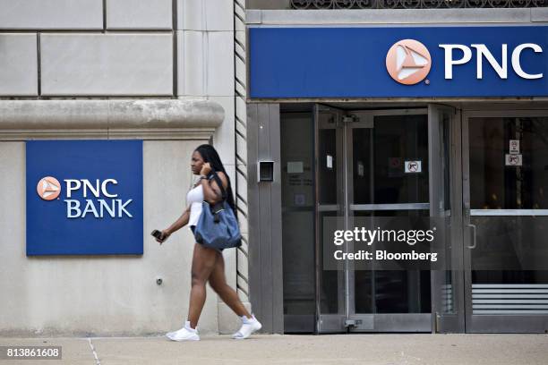 Pedestrian passes in front of a PNC Financial Services Group Inc. Bank branch in Peoria, Illinois, U.S., on Monday, July 10, 2017. PNC Financial...