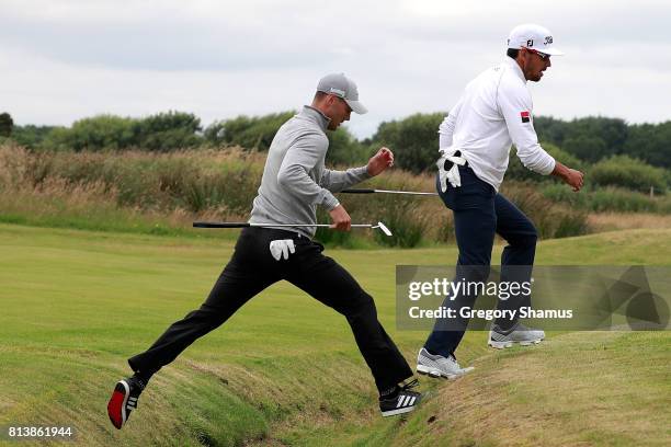 Rafa Cabrera-Bello of Spain and Martin Kaymer of Germany cross a ditch on the 9th hole during day one of the AAM Scottish Open at Dundonald Links...