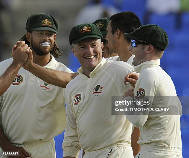 Australians Stuart MacGill Andrew Symonds and Michael Clarke celebrate after a West Indies out during the 2008 Digicel Home Series at the Sir Vivian...