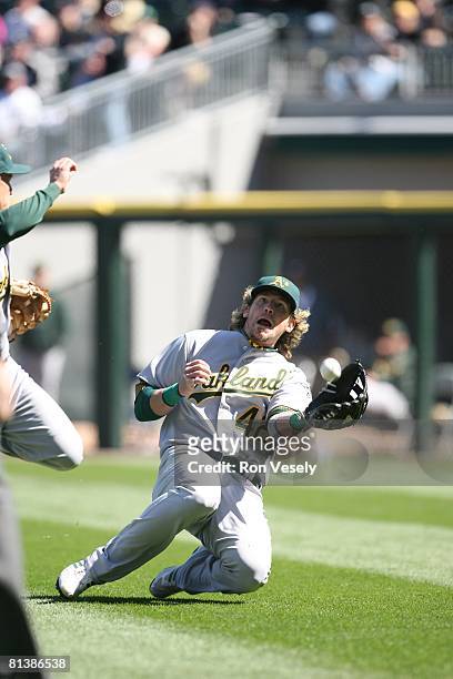 Travis Buck of the Oakland Athletics dives for a fly ball during the game against the Chicago White Sox at U.S. Cellular Field on Jackie Robinson Day...
