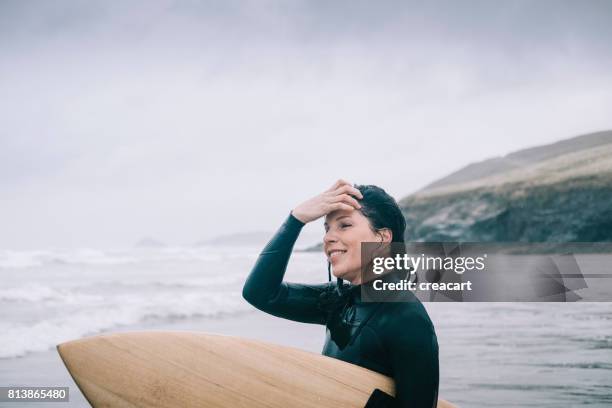 Candid Portrait of Female Surfer, Overcast rainy day, Cornwall.