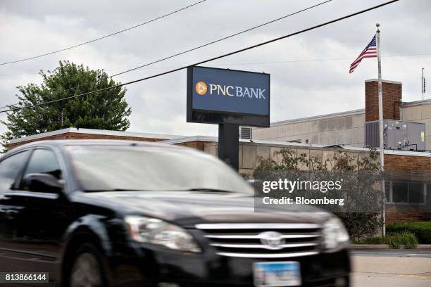 Vehicle passes in front of a PNC Financial Services Group Inc. Bank branch in Morton, Illinois, U.S., on Monday, July 10, 2017. PNC Financial...
