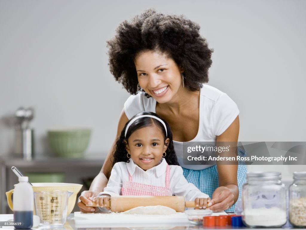 African mother and daughter baking