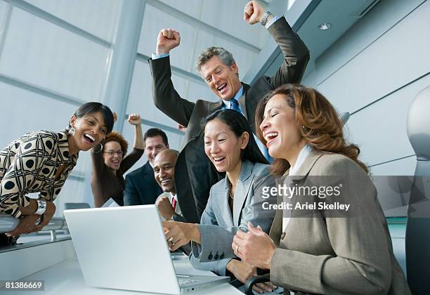 multi-ethnic businesspeople cheering at laptop - asian young executive laughing office bildbanksfoton och bilder