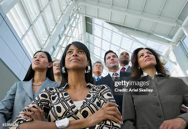 portrait of multi-ethnic businesspeople - group of businesspeople standing low angle view stock pictures, royalty-free photos & images