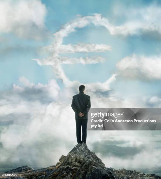 portuguese businessman looking at euro sign cloud - suit and tie stock pictures, royalty-free photos & images