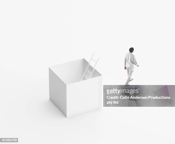 european businessman walking away from box - releasing stock pictures, royalty-free photos & images