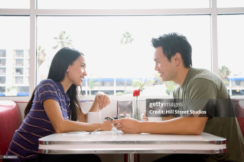 Asian couple smiling at each other