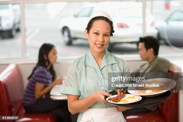 asian waitress holding tray of food - waitress booth stock pictures, royalty-free photos & images