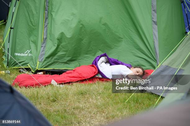 Person sleeps amongst tents at Glastonbury Festival, Worthy Farm, Somerset. PRESS ASSOCIATION Photo. Picture date: Sunday June 2017. Photo credit...