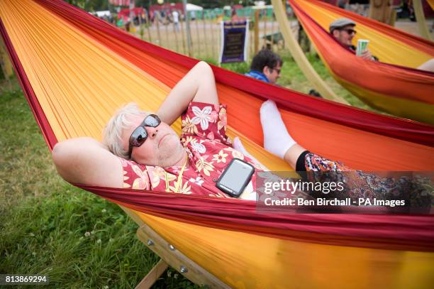 Man relaxes in a hammock at Glastonbury Festival, Worthy Farm, Somerset. PRESS ASSOCIATION Photo. Picture date: Sunday June 2017. Photo credit should...