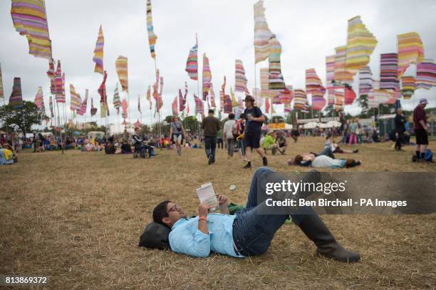 Man reads a book in West Holts at Glastonbury Festival, Worthy Farm, Somerset. PRESS ASSOCIATION Photo. Picture date: Sunday June 2017. Photo credit...