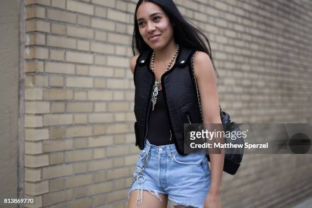 Guest is seen attending Landlord at Skylight Clarkson during Men's New York Fashion Week wearing a black vest and denim shorts on July 12, 2017 in...