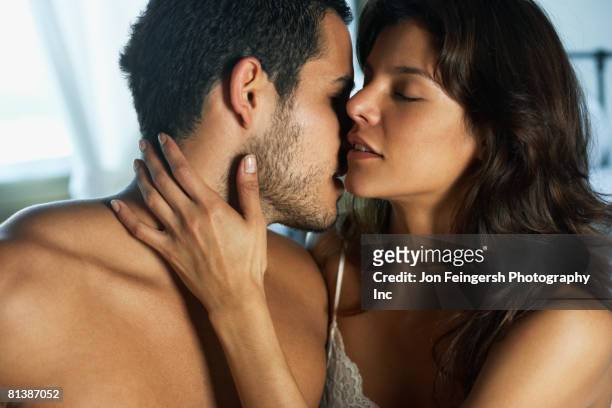 hispanic couple hugging - 性的行動 ストックフォトと画像