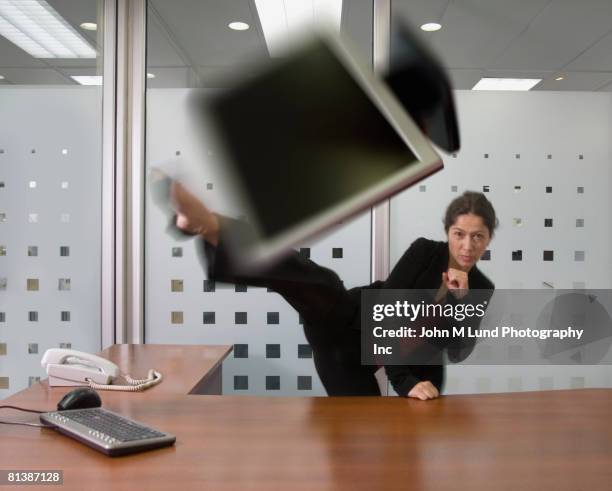 hispanic businesswoman kicking laptop - hög spark bildbanksfoton och bilder