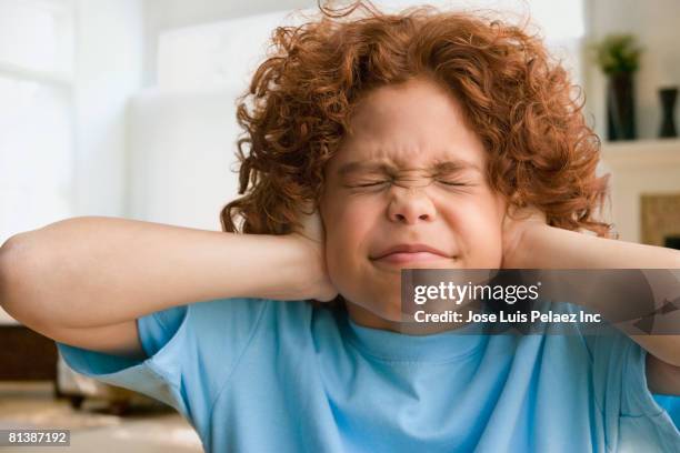 mixed race boy covering ears - hands covering ears stock pictures, royalty-free photos & images