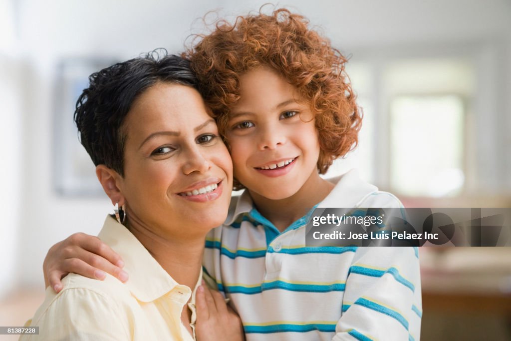 Mixed Race mother and son hugging