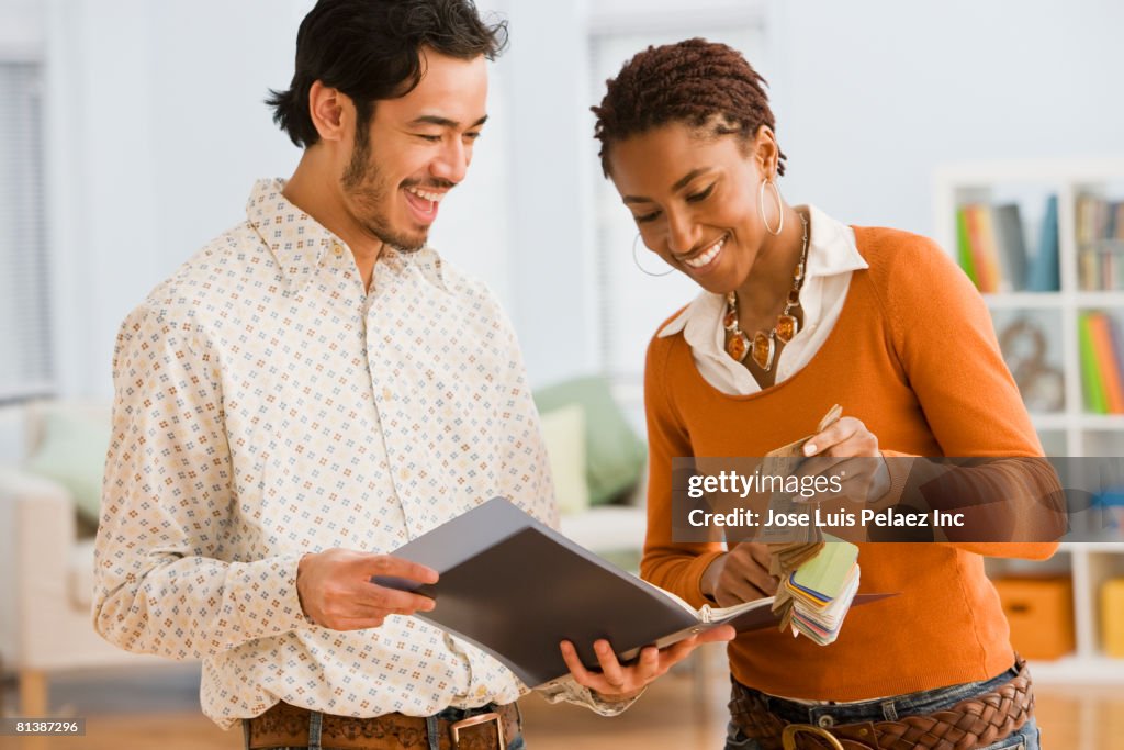 Multi-ethnic businesspeople looking at textile swatches