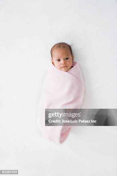 hispanic baby wrapped in pink blanket - babydecke stock-fotos und bilder