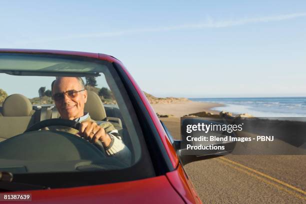 senior german man driving convertible car - nordeuropäischer abstammung stock-fotos und bilder