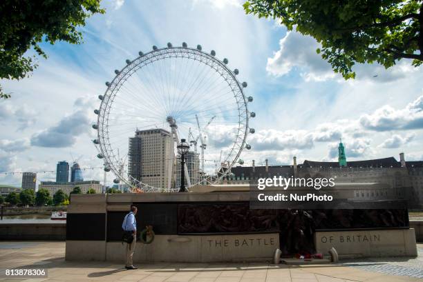 The Battle of Britain Monument is seen against the backdrop of the London Eye, in London on July 13, 2017. The Battle of Britain Monument in London...