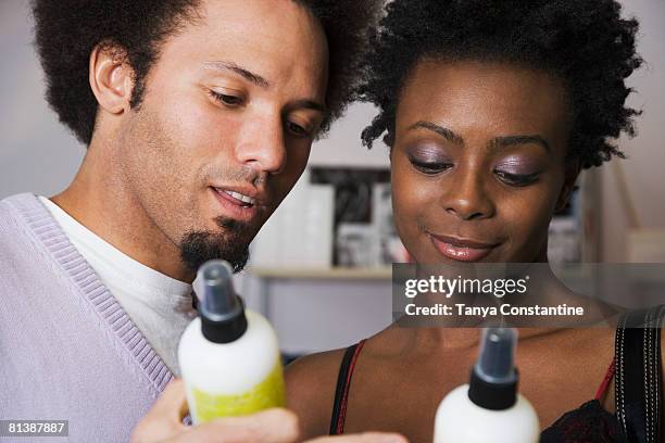 multi-ethnic couple looking at hair product - hair products ストックフォトと画像