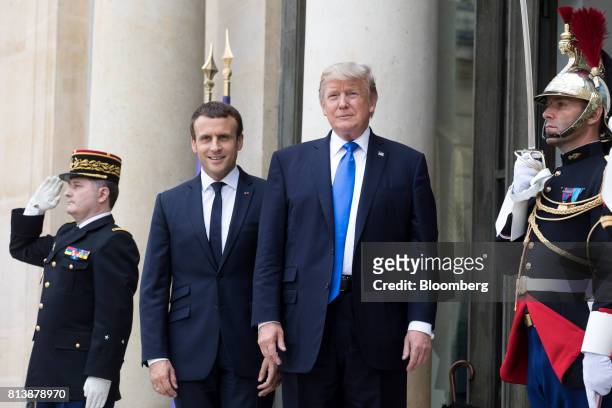 Emmanuel Macron, France's president, and U.S. President Donald Trump, pose for photographs at the Elysee Palace in Paris, France, on Thursday, July...