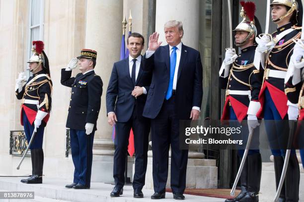 Emmanuel Macron, France's president, center left, and U.S. President Donald Trump, center right, pose for photographs at the Elysee Palace in Paris,...