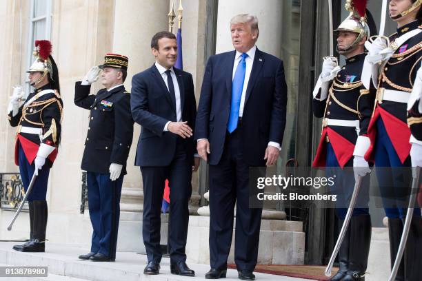 Emmanuel Macron, France's president, center left, and U.S. President Donald Trump, center right, pose for photographs at the Elysee Palace in Paris,...