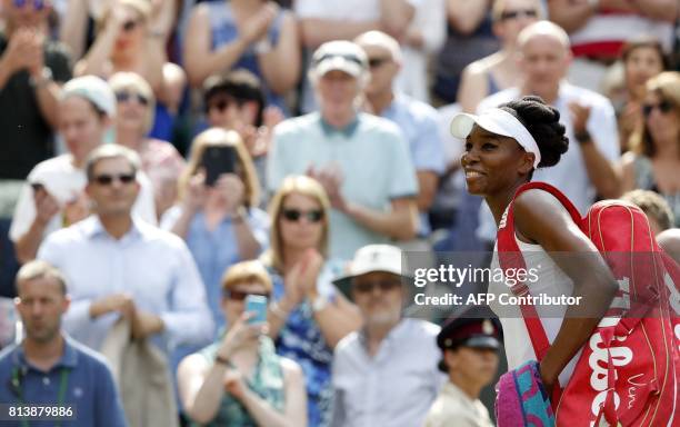Player Venus Williams leaves the court after beating Britain's Johanna Konta in their women's singles semi-final match on the tenth day of the 2017...