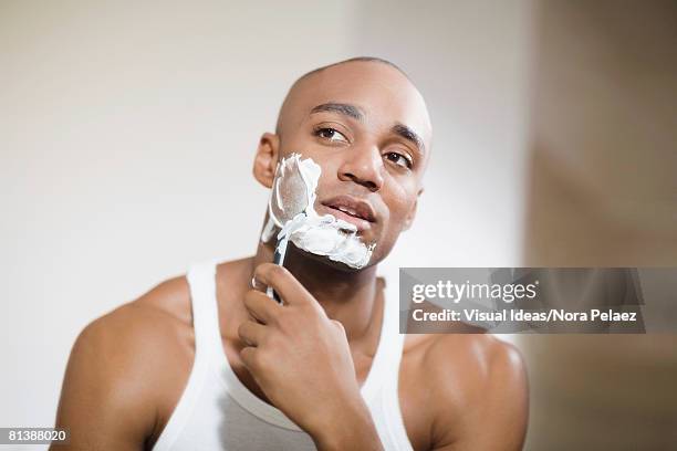 african man shaving face - shaving foto e immagini stock