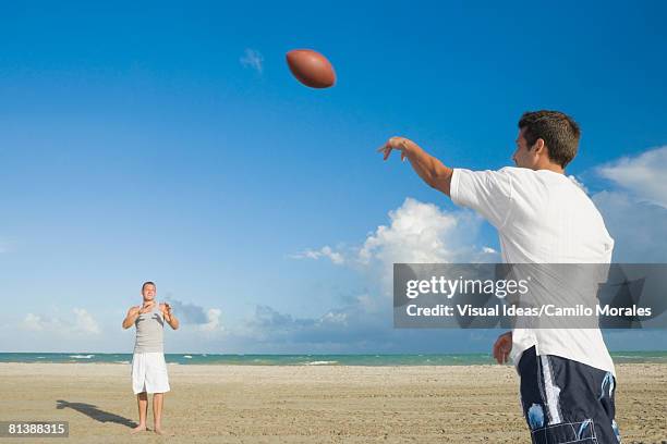 multi-ethnic men playing catch - catch 22 foto e immagini stock