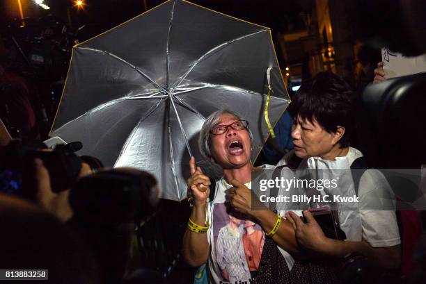 People mourn the death of jailed Chinese Nobel Peace laureate Liu Xiaobo during a demonstration outside the Chinese liaison office on July 13, 2017...